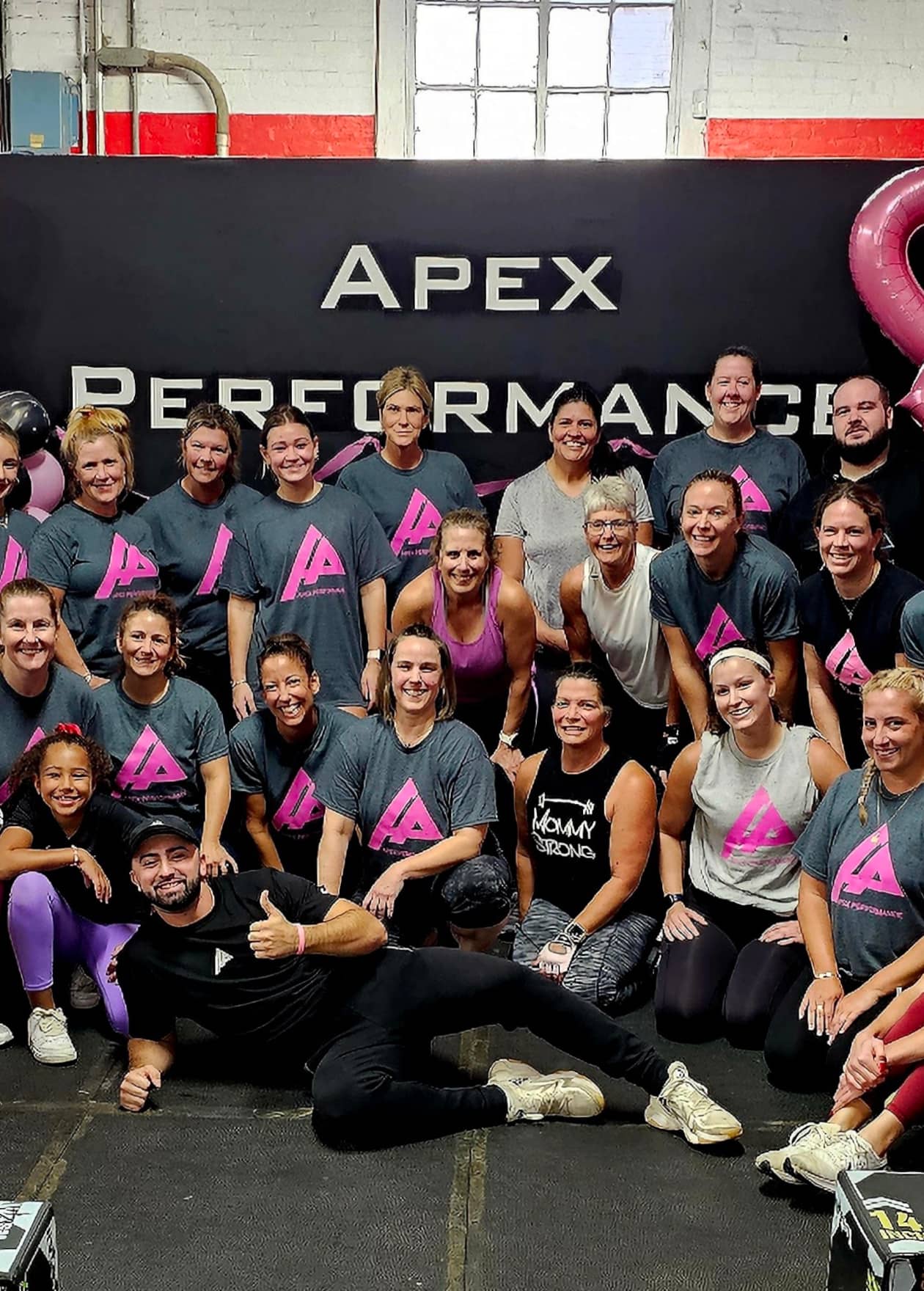 Apex Performance Gym members staff in pink t-shirts celebrating the barbells for cancer event.