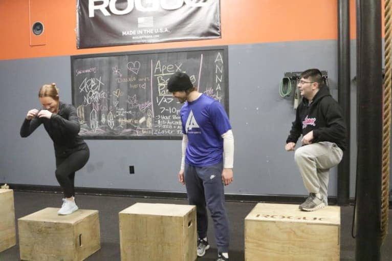 Members of Apex Performance Gym in Rockland County performing box jumps and other conditioning exercises in the HIIT bootcamp class.