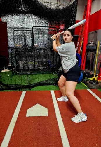 Focused batter perfecting swing mechanics at Apex Performance Gym, as part of their hitting and pitching class.