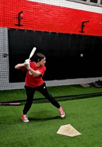Pitcher honing skills with a focus on form and accuracy at Apex Performance Gym's hitting and pitching class.