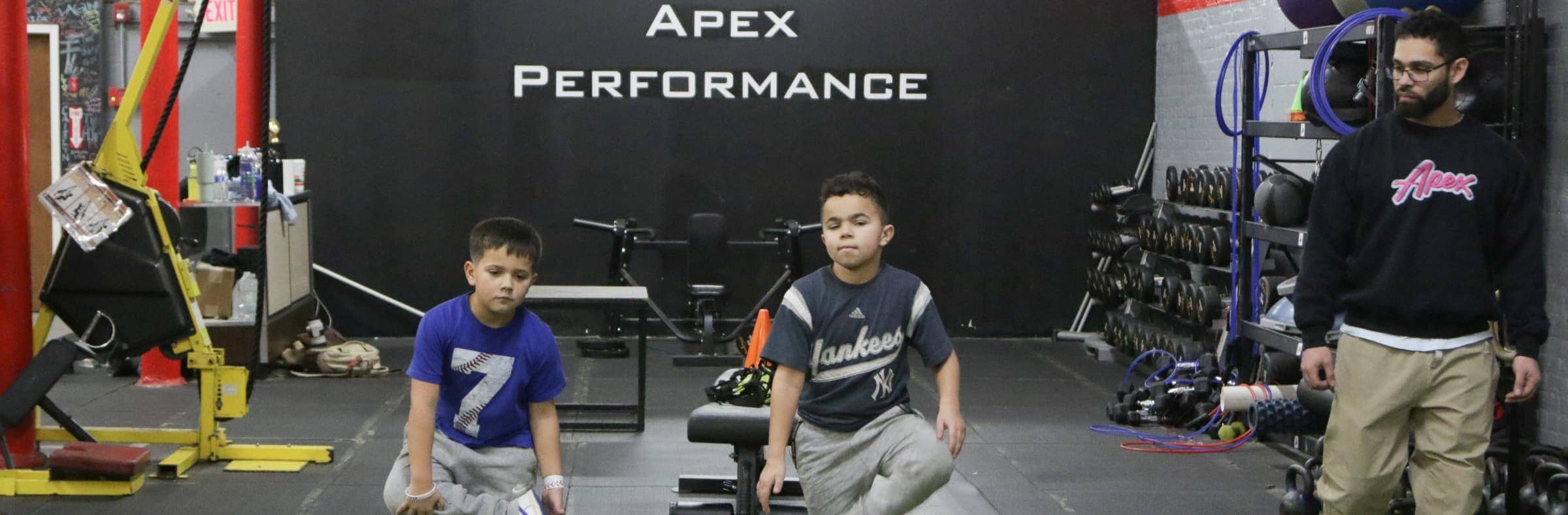 Young athletes at Apex Performance Gym participating in a youth fitness class, with a focus on developing balance and coordination.