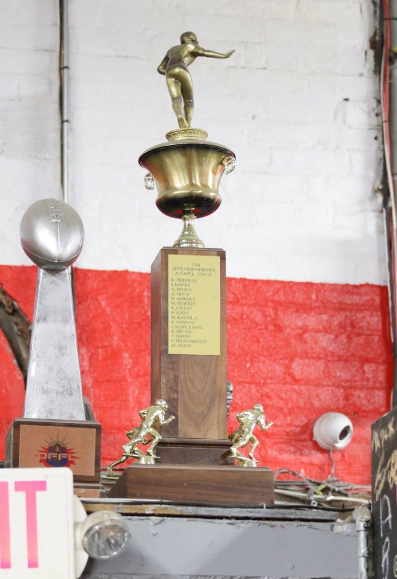 Trophy on display at Apex Performance Gym, symbolizing achievements in coaching excellence and athletic performance.